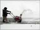  ?? ASSOCIATED PRESS ?? A MAN CLEARS SNOW from sidewalk Sunday, Feb. 11, 2018, in Chicago.