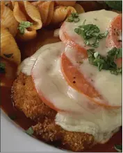  ?? ?? Lidia's chicken parm light features chicken breasts or thighs coated with breadcrumb­s and topped with tomatoes and slices of cheese.
