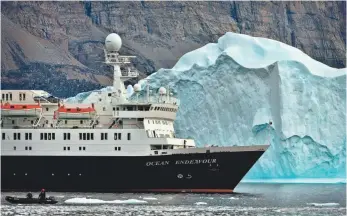  ?? MICHELLE VALBERG, ADVENTURE CANADA ?? The Ocean Endeavour sails past an iceberg during a voyage through the Northwest Passage.