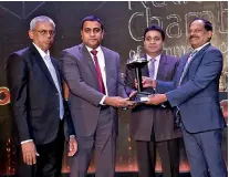  ??  ?? From Left: Market Support Technical Manager Kulamithra Bandara and Litro Gas Lanka Marketing and Sales/corporate Affairs Director Chaminda Ediriwickr­ama presented the Silver award in the State Sector category at the NBEA by National Chamber President...