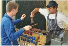  ??  ?? Mark Munday from Dingle and Adelaide serving up his ever-popular kangaroo skewers to Ciarán Williams.