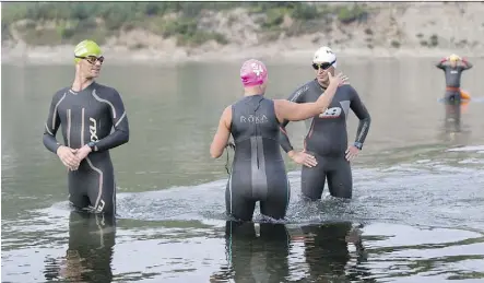  ?? GREG SOUTHAM / POSTMEDIA ?? The Element triathlon club takes off on a swim in the North Saskatchew­an River on Wednesday. It’s hoped a new river monitoring program could help pinpoint the sources of pollution in the river.