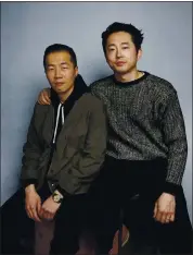  ?? ASSOCIATED PRESS ARCHIVES ?? Lee Isaac Chung, left, and Steven Yeun pose for a portrait to promote “Minari” at the 2020 Sundance Film Festival.