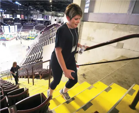  ?? DAN JANISSE ?? Jennifer Spafford, from Hub Internatio­nal Limited climbs the steps of the WFCU Centre on Wednesday during the United Way Windsor-Essex County’s 10th annual iClimb event. Proceeds from the fundraiser support local mental health and counsellin­g programs.