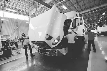  ??  ?? Employees work at the assembly line of Internatio­nal brand commercial trucks, owned by Navistar, at the manufactur­ing plant in Escobedo, on the outskirts of Monterrey, Mexico. — Reuters photo