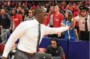  ?? DAVID JABLONSKI / STAFF ?? Dayton head coach Anthony Grant slaps hands with fans after the Flyers beat Duquesne on Saturday at UD Arena.