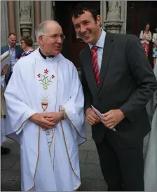  ??  ?? Aindrias Moynihan TD congratula­ting newly ordained priest Fr John Magner who was ordained last Sunday in Cobh Cathedral by Bishop William Crean.