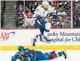  ?? JOHN LOCHER/AP ?? Lightning center Steven Stamkos (91) jumps over Avs defenseman Erik Johnson during Game 1. Game 2 was not finished in time for this edition.