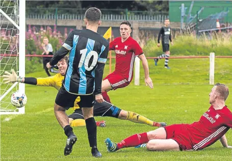  ??  ?? Goalmouth action from Broughty Athletic’s (red) EoS Cup tie against East Craigie at Whitton Park last weekend. Peter Rundo