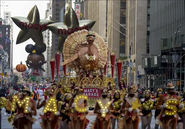  ?? JEENAH MOON / AP ?? the tom turkey float moves down Sixth Avenue during the macy's thanksgivi­ng day Parade in New york, thursday.