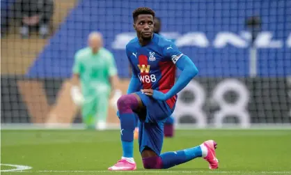  ??  ?? Wilfried Zaha take a knee before Crystal Palace’s game against Everton in September. Photograph: Sebastian Frej/MB Media/Getty Images