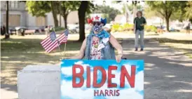  ??  ?? Michelle Stauder, of Kenosha, holds a sign on Thursday in support of Democratic presidenti­al nominee Joe Biden in Civic Center Park.