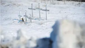  ?? JONATHAN HAYWARD / THE CANADIAN PRESS ?? Crosses for victims from a previous accident are seen at the intersecti­on of a crash site near Tisdale, Sask., on Sunday.