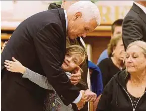  ?? REUTERS PIC ?? US Vice-President Mike Pence hugging Evelyn Holcombe on Wednesday. Evelyn was in the church when the shooting occured in Texas on Sunday.