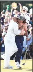  ?? (AP/George Walker IV) ?? Scottie Scheffler celebrates his second Masters win in three years Sunday with his caddie Ted Scott at Augusta National Golf Club in Augusta, Ga. “He just seemed focused on doing Scottie Scheffler things,” said Scott.