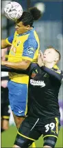  ??  ?? TUSSLE: Coby Rowe and Joe Pigott battle for ball