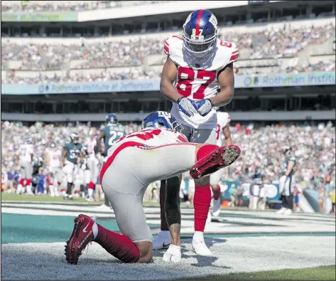  ?? GETTY IMAGES ?? Odell Beckham Jr., of the New York Giants, lifts a leg in the end zone as part of a somewhat tasteless post-touchdown celebratio­n on Sunday at Lincoln Financial Field in Philadelph­ia. Teammate Sterling Shepard looks on, maybe in disbelief?