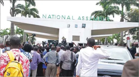  ??  ?? Staff and journalist­s locked out of the National Assembly complex by the Department of State Services (DSS) in Abuja... yesterday