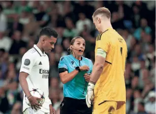  ?? REUTERS ?? On the job: Referee Stephanie Frappart talks to Celtic’s Joe Hart before Real Madrid’s Rodrygo takes a penalty kick during a Champions League game. A highlight of the announced list of match officials was the presence of women referees, a first in the history of the men’s football World Cup.