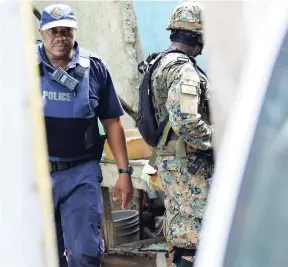  ?? NORMAN GRINDLEY/CHIEF PHOTO EDITOR ?? Security forces assigned to the zone of special operations carry out a search in Denham Town, west Kingston, yesterday.