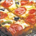  ?? ?? IT’S FOR SQUARES: Thicker-crust Detroit-style pizza is on the rise as locals still swear by the classic NY slice.