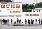  ?? Ringo H.W. Chiu Associated Press ?? A LINE forms to enter a Culver City gun store on March 15, 2020. The California Department of Justice shares its data on gun buyers with researcher­s.