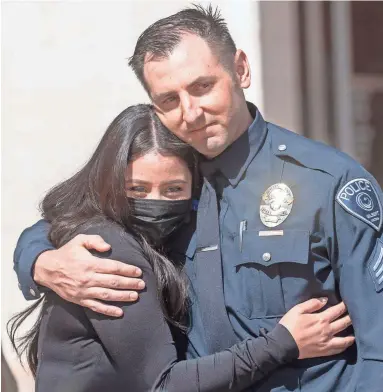  ?? NICK OZA/THE REPUBLIC ?? Idalia Ontiveros, wife of Gilbert police Officer Rico Aranda, hugs Sgt. Mathew Reale at a news conference Wednesday updating Aranda’s status after he was hit and critically injured by a man in a stolen vehicle last week.