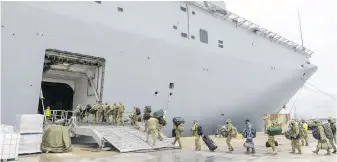  ?? AUSTRALIA DEFENCE FORCE VIA AP ?? Soldiers load onto HMAS Adelaide in Brisbane before departing for Tonga with relief supplies following an undersea volcanic eruption and tsunami near the islands.