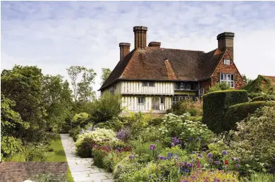  ??  ?? Right Great Dixter’s famous mixed Long Border is deeply layered with shrubs and perennials, and dotted with bulbs and annuals to provide a long season of colour.