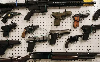  ?? AP PHOTO/JAE C. HONG ?? Seized firearms are displayed during a news conference on Wednesday, in Los Angeles.