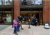  ?? ?? Left: Federica Risuglia and Jose Moreno looked at a display at the new Google store. Below: Staffer Kyra Cooper (right) talked with a customer.