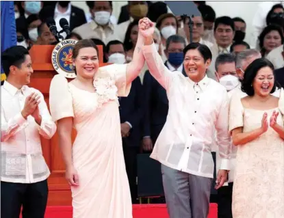  ?? AARON FAVILA / AP ?? Philippine President Ferdinand Romualdez Marcos (center right) and Vice-President Sara Duterte, daughter of former Philippine president Rodrigo Duterte, greet each other during the inaugurati­on ceremony at the National Museum on June 30 in Manila, the Philippine­s. Marcos was sworn in as the country’s 17th president.