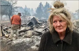  ?? RAY CHAVEZ — STAFF PHOTOGRAPH­ER ?? Cathy Fallon waits as her son, Gabriel Fallon, sifts through the remains of her home in Paradise on Friday. Fallon and her husband were able to save their 14 horses.