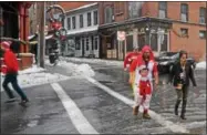  ?? NICHOLAS BUONANNO- NBUONANNO@TROYRECORD.COM ?? People walk from Saratoga City Tavern to the Ice House in downtown Saratoga Springs Saturday afternoon during the 11th annual Ugly Sweater Pub Crawl.