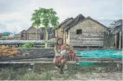  ?? ADAM FERGUSON PHOTOS/THE NEW YORK TIMES ?? The families on Beniamina Island are the descendant­s of migrants resettled by the British government in the 1950s.