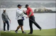  ?? ERIC RISBERG — THE ASSOCIATED PRESS ?? Ted Potter Jr. is greeted by his caddie on the 18th green of the Pebble Beach Golf Links after winning the AT&T Pebble Beach National Pro-Am golf tournament Sunday in Pebble Beach At left is Sean Kell.