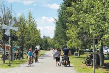  ?? MARCO FORTIER LE DEVOIR ?? Les cyclistes de la piste du P’tit train du Nord sont de retour à Val-David. Les commerçant­s sont prêts à les accueillir, mais certains résidents sont moins pressés d’accueillir les foules.