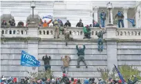  ?? JOSE LUIS MAGANA/ASSOCIATED PRESS FILE PHOTO ?? Violent insurrecti­onists loyal to former President Donald Trump scale a wall of the U.S. Capitol on Jan. 6 in Washington.