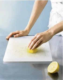  ?? Real Simple/AP file ?? Scrub your white plastic cutting board with half a lemon, then set it out in the sun for a few hours.