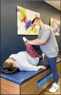  ??  ?? Kelly O’Neal, 51, of Kettering at an assisted stretching at StretchLab in Centervill­e on March 8.