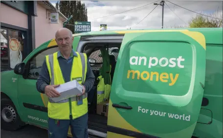  ??  ?? Mike Keane the Postman at Moyvane in North Kerry pictured on his rounds in Moyvane this week as the streets were deserted due to the Coronaviru­s . Photo By Domnick Walsh © Eye Focus