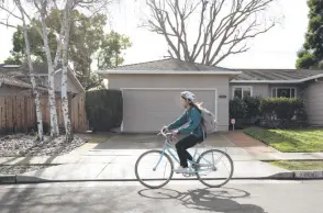  ?? ?? Wang rides her bike to her shift at Happy Lemons boba tea shop, in Cupertino, California.