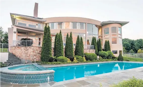  ??  ?? The downstairs recreation area in this Ellicott City house leads outside to a lap pool and hot tub surrounded by a flagstone patio.