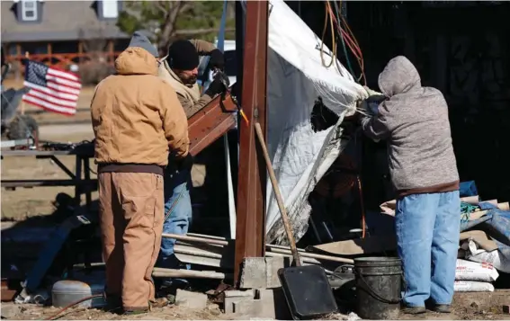  ?? Photo: AP/Butch Dill. ?? Friends and family help as they recover from a tornado that ripped through Central Alabama earlier this week along County Road 140 where loss of life occurred Saturday, January 14, 2023, in White City, Autauga County, Alabama.