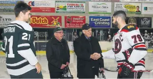  ?? JASON MALLOY/THE GUARDIAN ?? Frankie McIntosh and Charlie Gillis shake hands with the players following Tuesday’s ceremonial puck drop before the UPEI Panthers-UNB Reds men’s hockey game. From left are UPEI Panthers assistant captain Filip Rydstrom, McIntosh, Gillis and UNB captain Marcus McIvor.