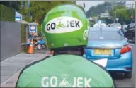  ?? AFP ?? A driver with motorbike taxi service Go-Jek in Jakarta. Last year the Indonesian startup raised $550 million, led by private equity firms KKR & Co and Warburg Pincus.