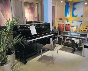  ?? PHOTOS: DINA MISHEV/THE WASHINGTON POST ?? Sometimes the keys on this upright piano in the ABBA museum start playing by themselves. That’s because they’re connected to Benny Andersson’s Skeppsholm­en studio. “When Benny starts playing, you will be able to listen,” a sign says.