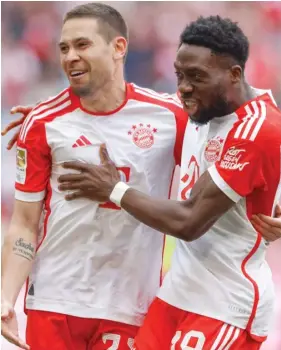  ?? PLAYING TODAY ?? Raphael Guerreiro (left) celebrates with Alphonso Davies.
PLAYING TOMORROW