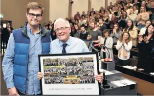  ?? PHOTO: GREGOR RICHARDSON ?? Fond farewell . . . Law student Tim Austen presents lecturer Prof Mark Henaghan with a board of finalists’ pictures through the years.