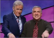  ?? PROVIDED BY ‘JEOPARDY!’/FILE ?? New Paltz resident Francois Barcomb, right, is shown on the ‘Jeopardy!’ set with host Alex Trebek after winning the game show’s $100,000 Teachers Tournament.